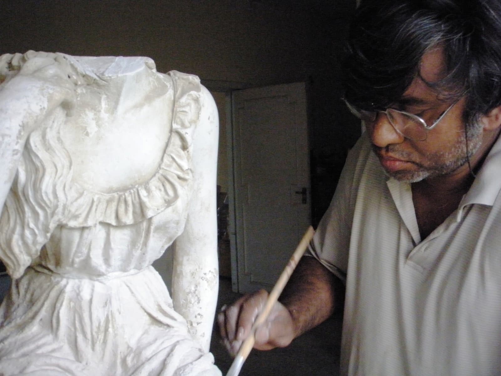 Shahid Hussain finishing a figure in the studio